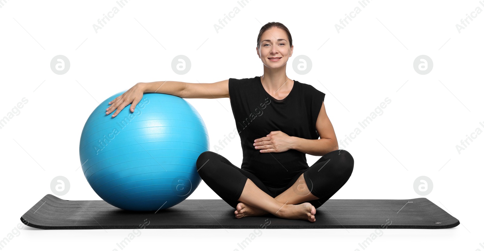 Photo of Beautiful pregnant woman with fitball on exercise mat against white background