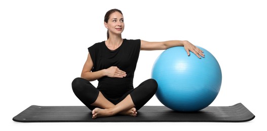 Beautiful pregnant woman with fitball on exercise mat against white background