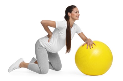 Beautiful pregnant woman with fitball doing exercises on white background