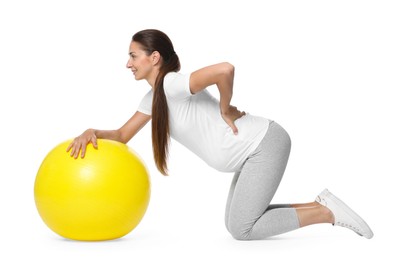 Photo of Beautiful pregnant woman with fitball doing exercises on white background