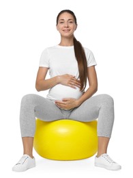 Beautiful pregnant woman doing exercises on fitball against white background