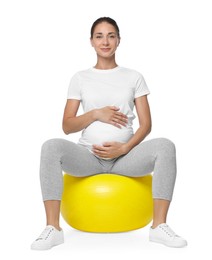 Beautiful pregnant woman doing exercises on fitball against white background