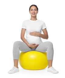 Photo of Beautiful pregnant woman doing exercises on fitball against white background