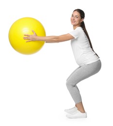 Photo of Beautiful pregnant woman with fitball doing exercises on white background