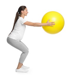 Beautiful pregnant woman with fitball doing exercises on white background