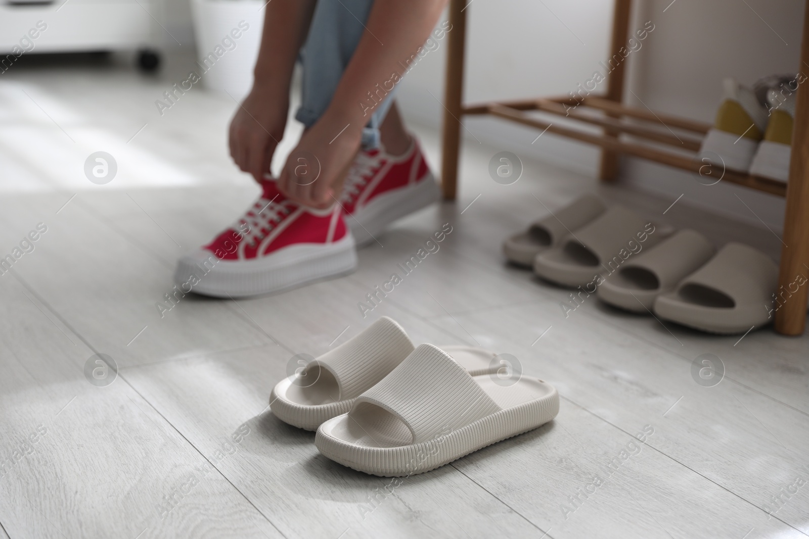 Photo of Woman changing into slippers at home, closeup