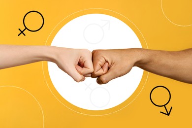 Gender equality concept. Man and woman making fist bump on orange background, closeup