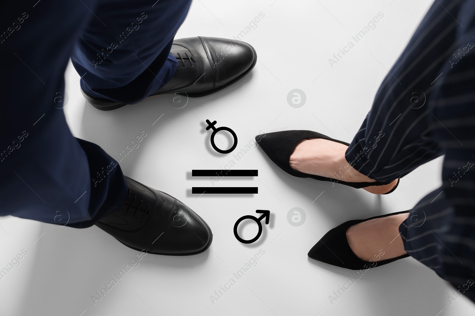 Image of Equation with female and male signs on floor between man and woman