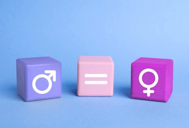 Image of Cube with equals sign between female and male gender symbols on light blue background