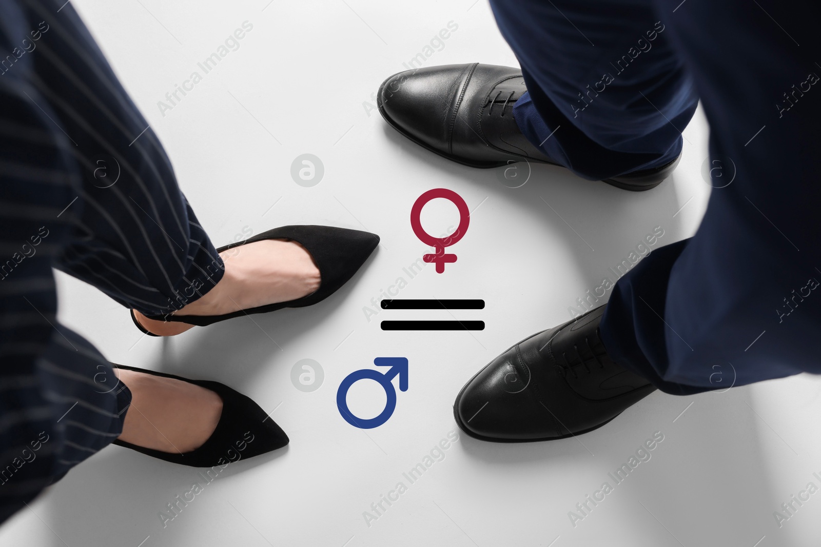 Image of Equation with female and male signs on floor between man and woman