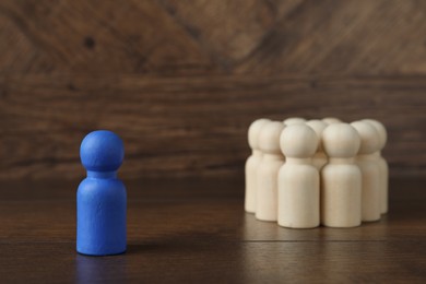 Photo of Blue piece among wooden ones on table