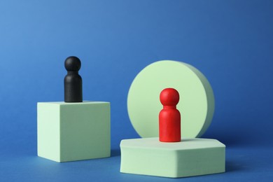 Photo of Different figures on stands against blue background