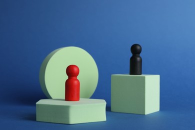 Photo of Different figures on stands against blue background