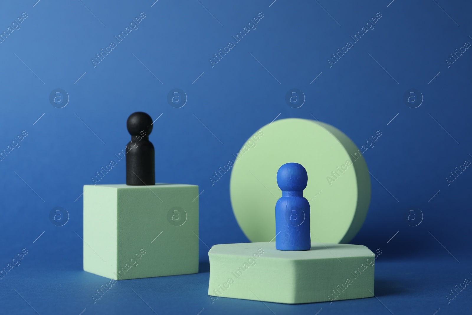 Photo of Different figures on stands against blue background