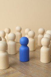 Photo of Blue piece among wooden ones on table