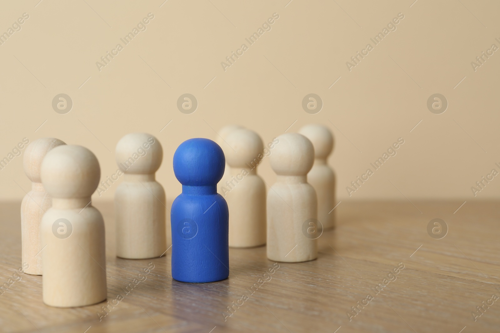 Photo of Blue piece among wooden ones on table