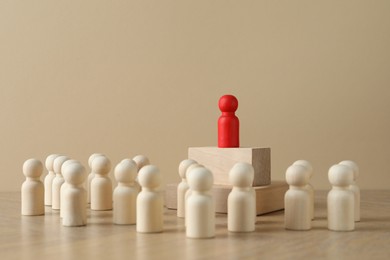 Red piece among wooden ones on table