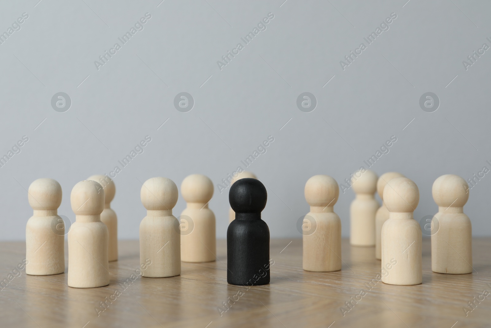 Photo of Black piece among wooden ones on table