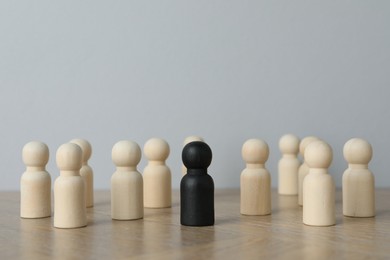 Black piece among wooden ones on table