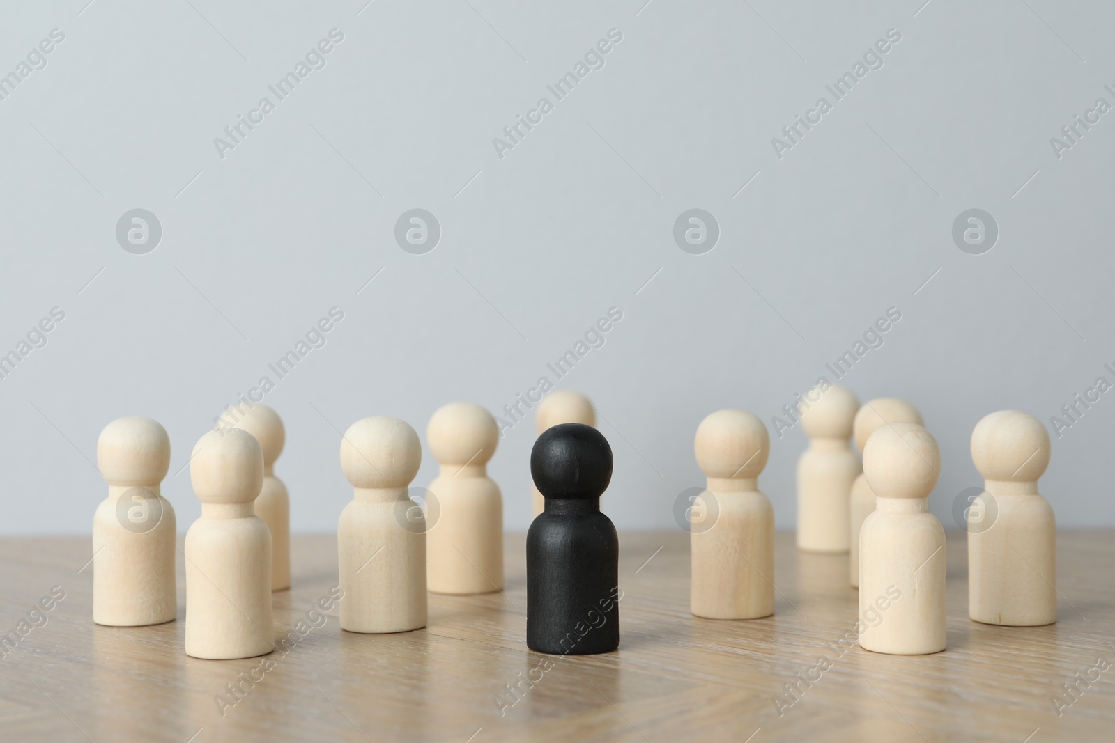 Photo of Black piece among wooden ones on table