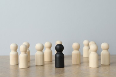 Photo of Black piece among wooden ones on table