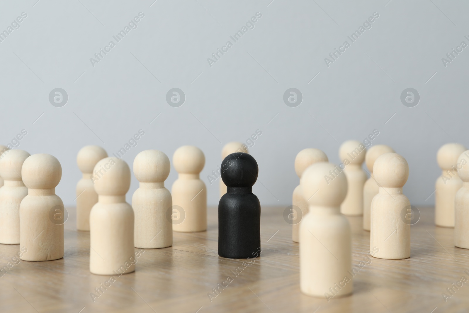 Photo of Black piece among wooden ones on table