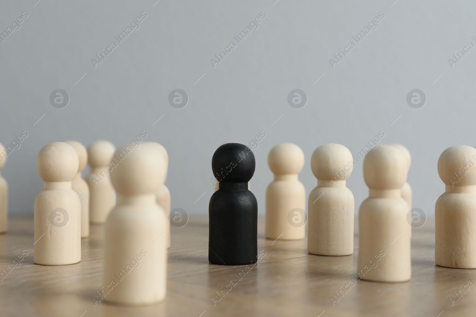 Photo of Black piece among wooden ones on table