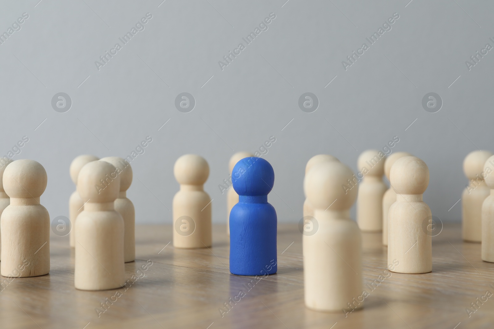 Photo of Blue piece among wooden ones on table