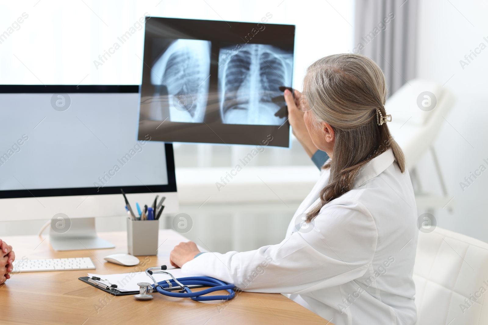 Photo of Lung disease. Doctor examining chest x-ray in clinic