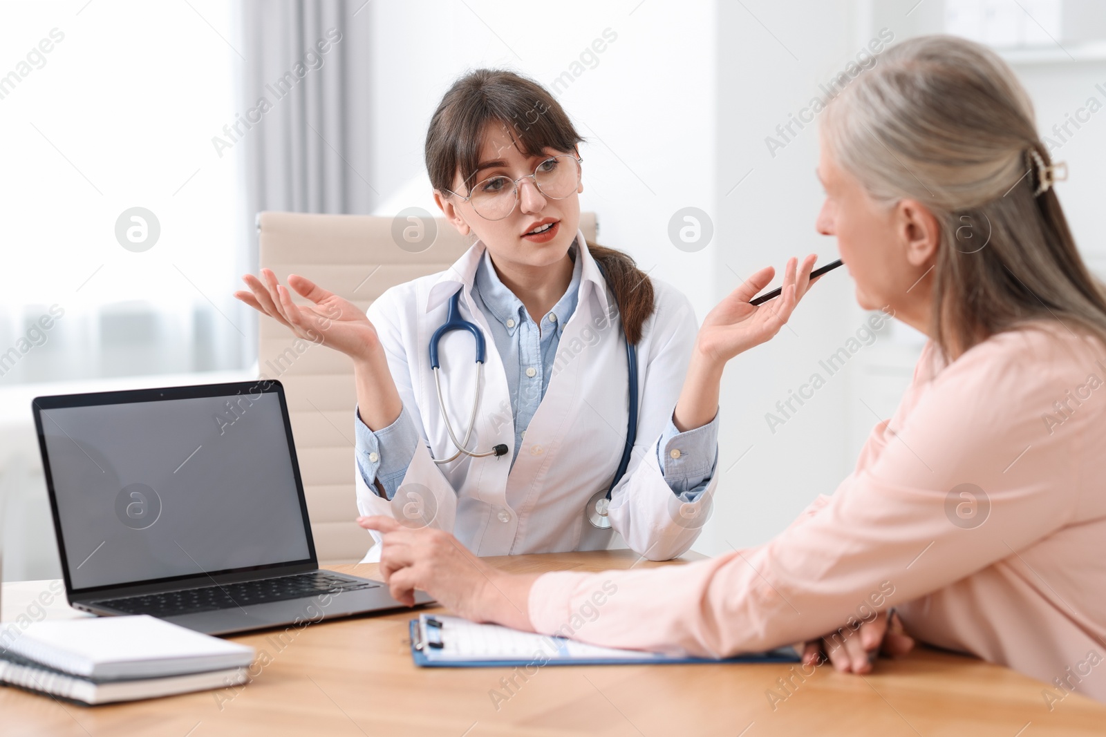 Photo of Lung disease. Doctor consulting patient at table in clinic