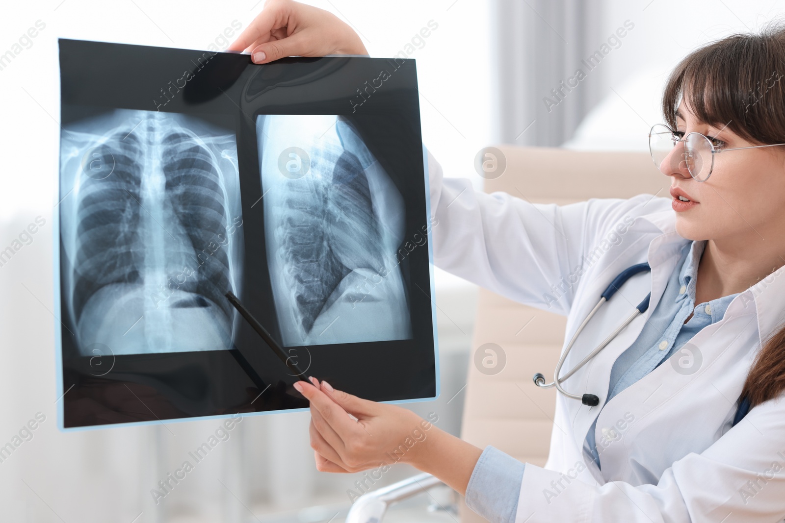 Photo of Lung disease. Doctor examining chest x-ray in clinic