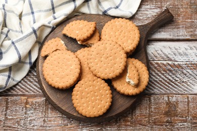 Tasty sandwich cookies on wooden table, top view