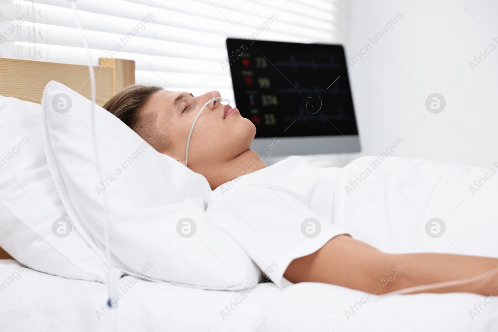 Photo of Coma patient. Young man sleeping in hospital bed