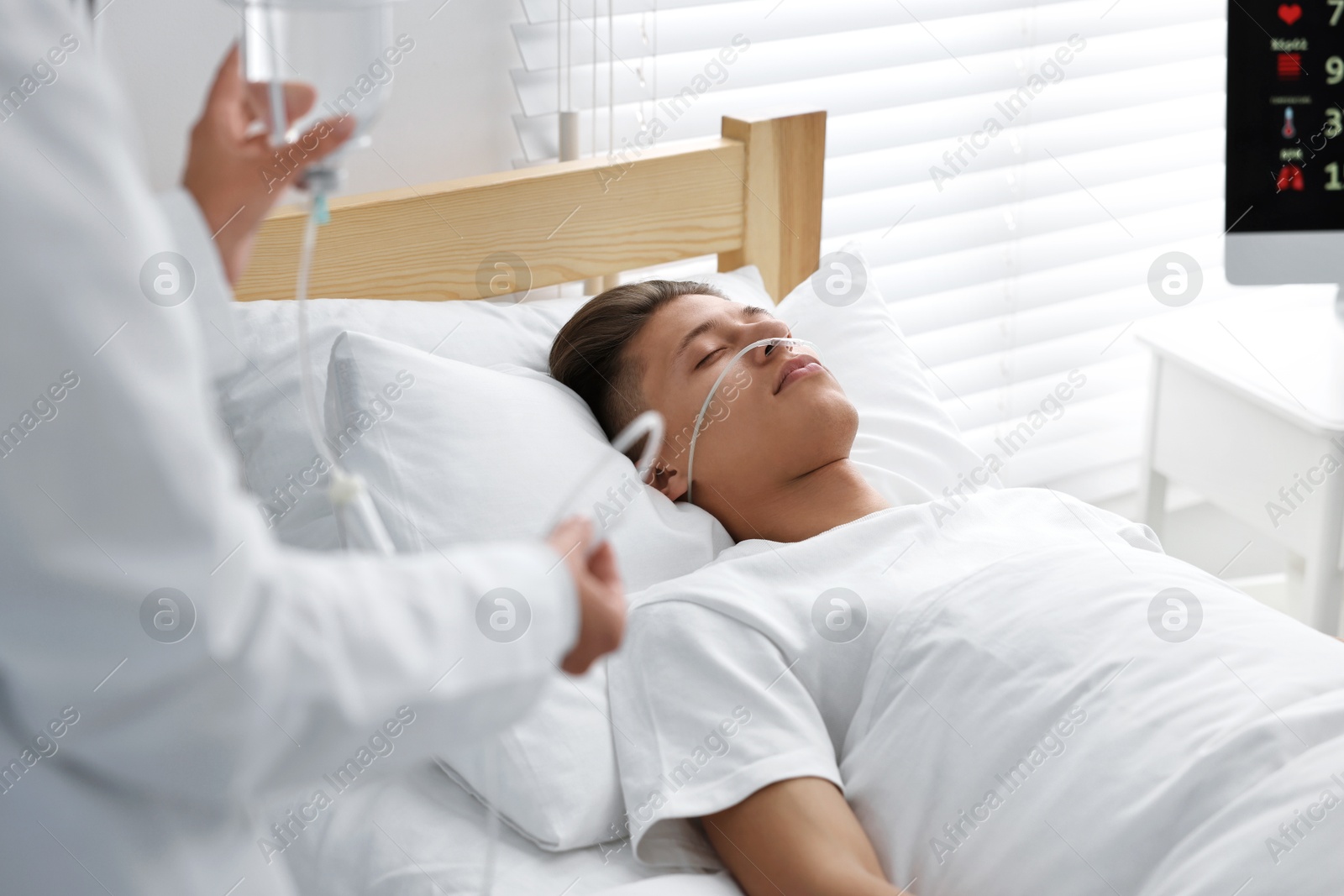 Photo of Coma patient. Doctor near unconscious young man in hospital, closeup