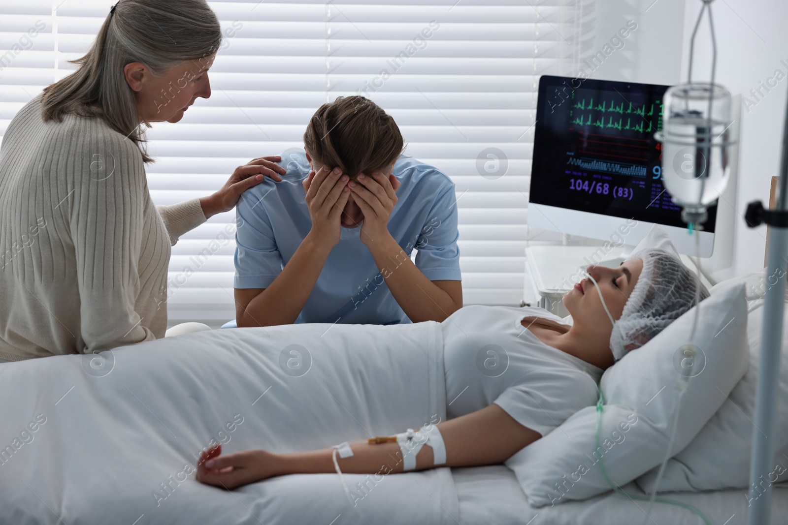 Photo of Coma patient. Sad relatives near sleeping young woman in hospital