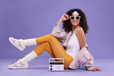 Photo of Aerobics. Woman with radio receiver on purple background
