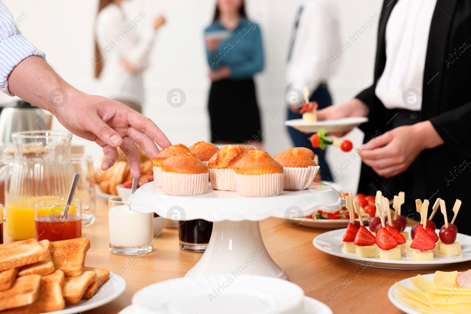 Photo of Coworkers having business lunch in restaurant, closeup