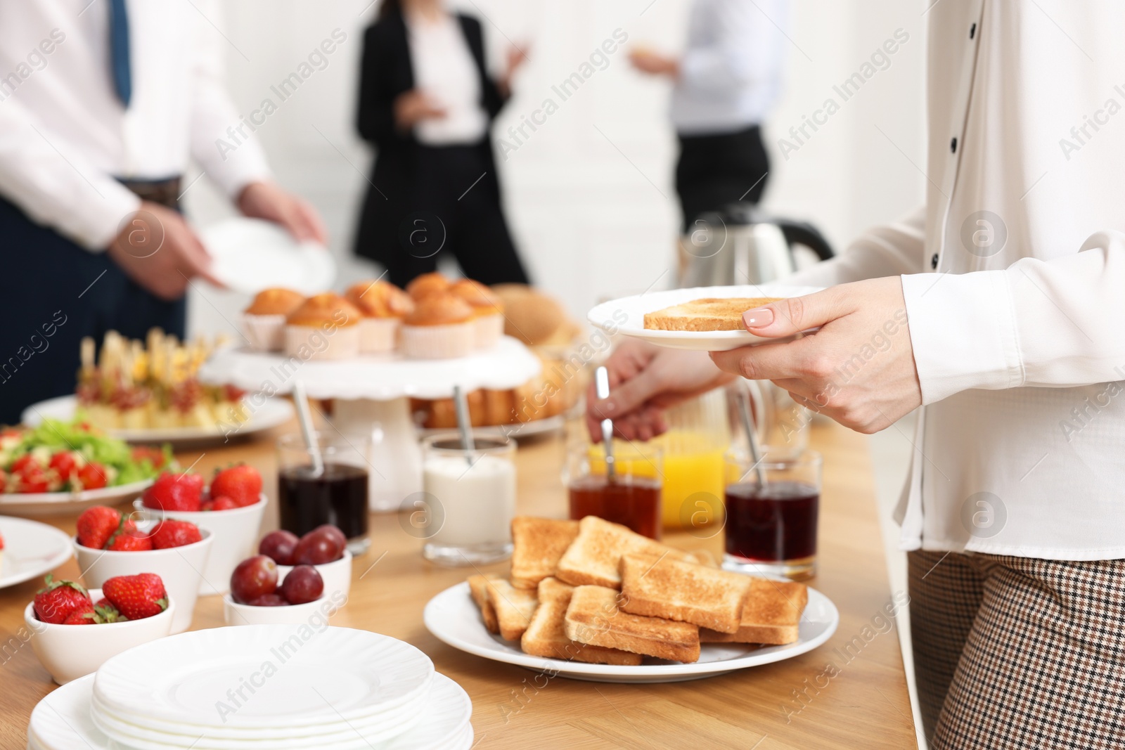 Photo of Coworkers having business lunch in restaurant, closeup