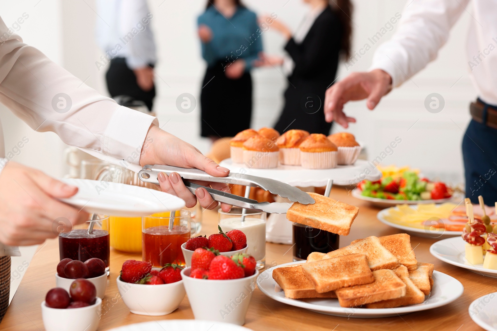 Photo of Coworkers having business lunch in restaurant, closeup