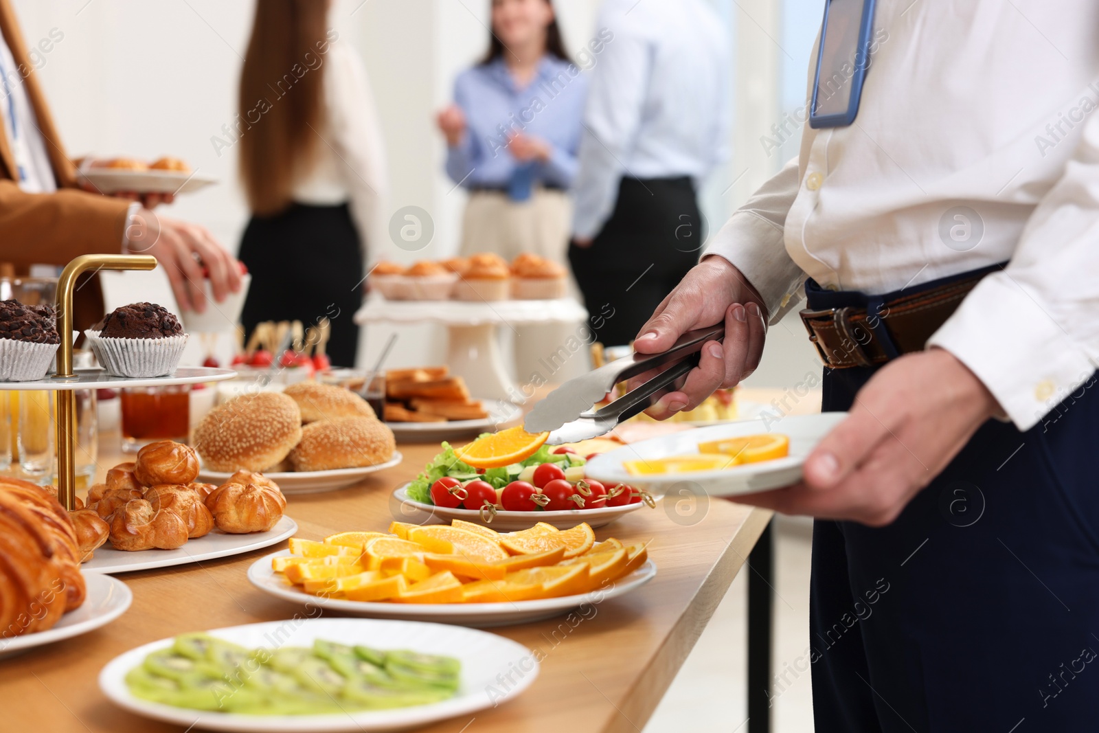 Photo of Coworkers having business lunch in restaurant, closeup