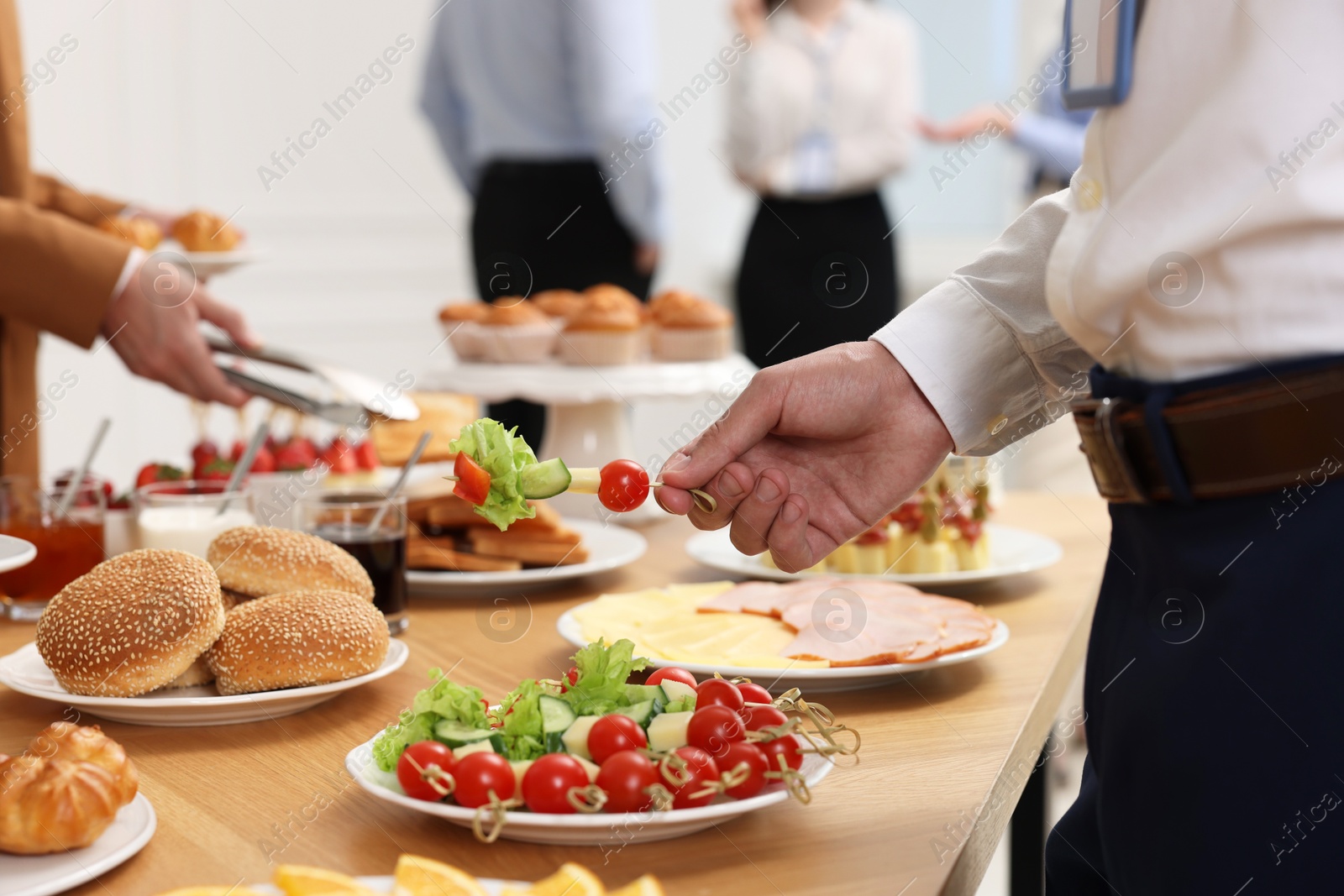 Photo of Coworkers having business lunch in restaurant, closeup