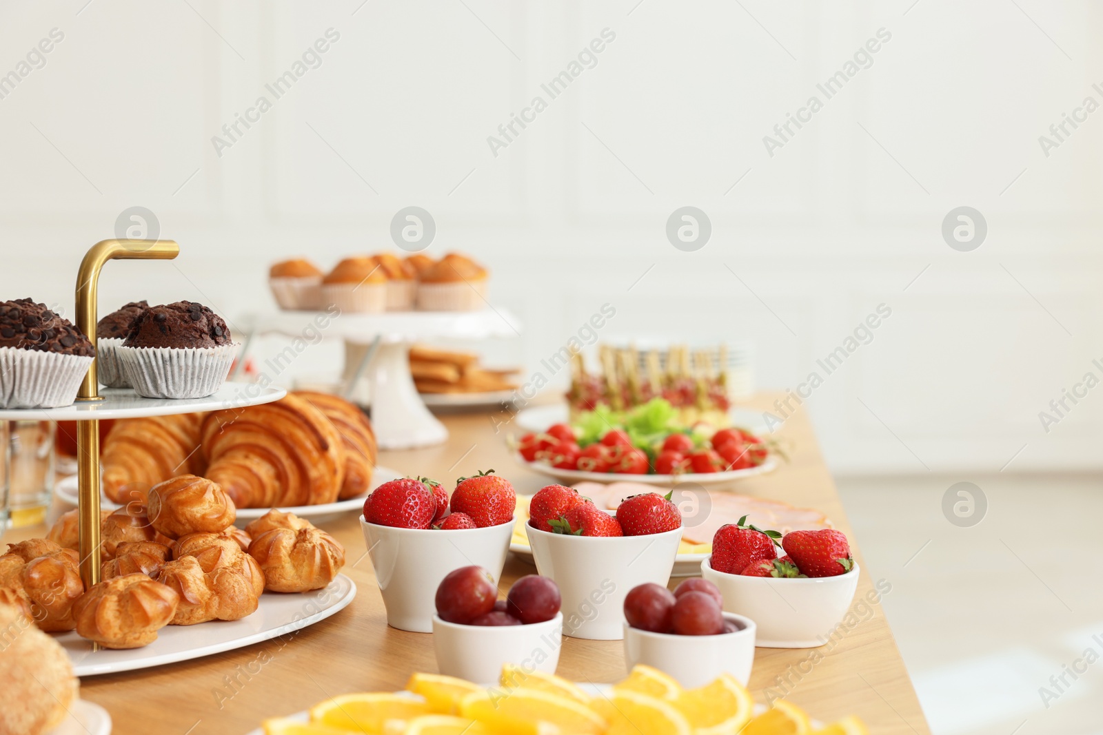 Photo of Different meals served on wooden table indoors. Buffet menu