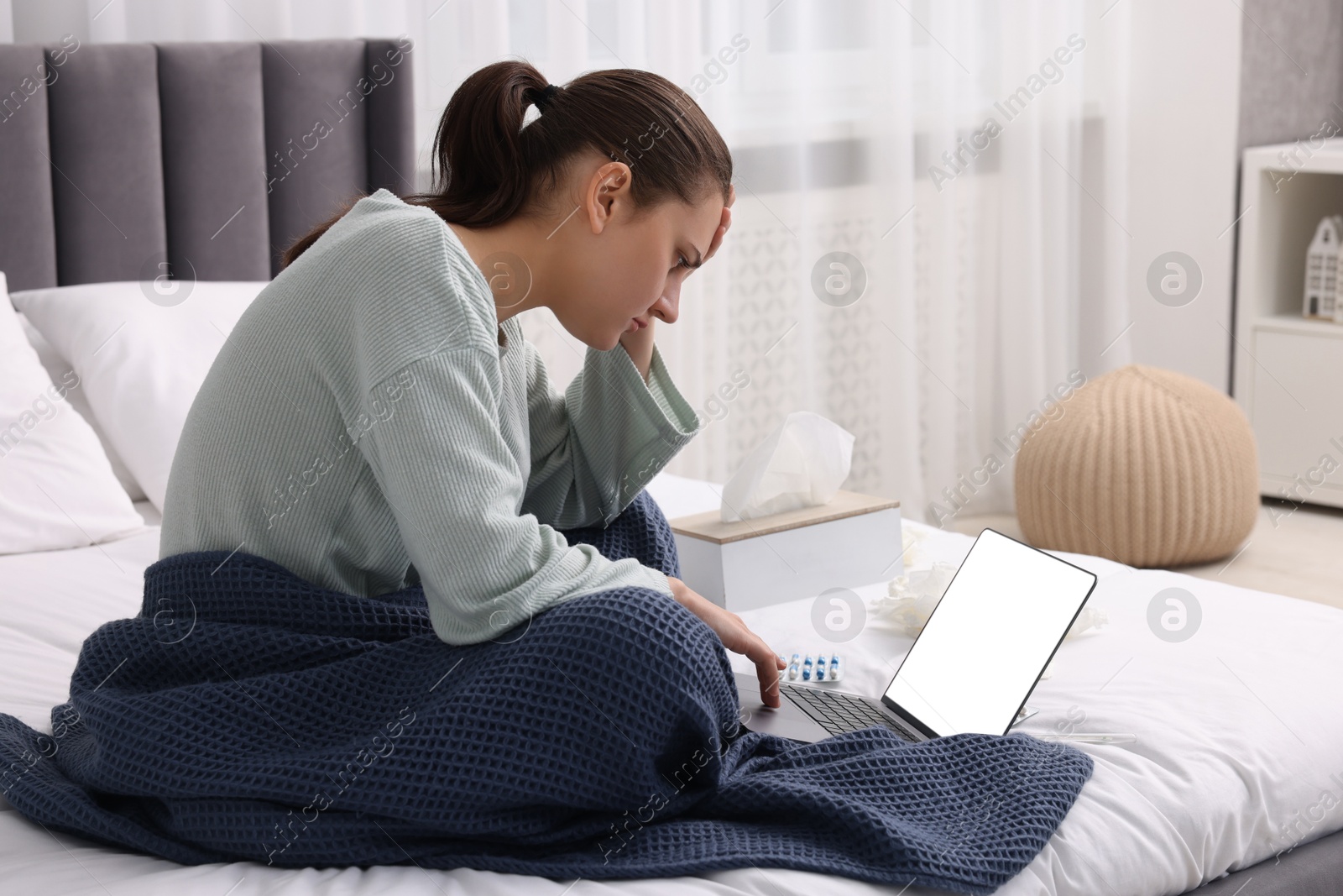 Photo of Sick woman having online consultation with doctor via laptop at home