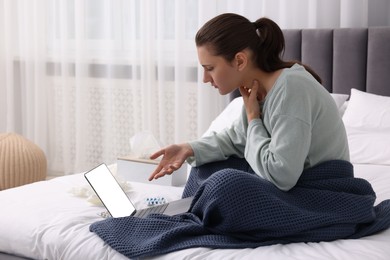 Photo of Sick woman having online consultation with doctor via laptop at home