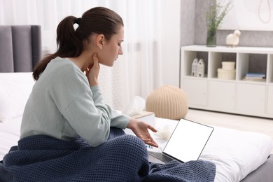 Photo of Sick woman having online consultation with doctor via laptop at home