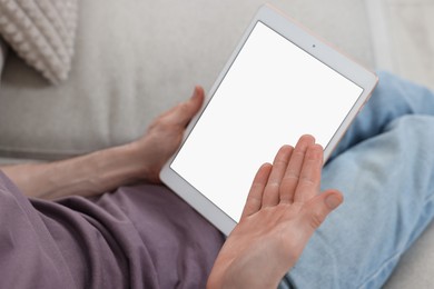 Photo of Sick man having online consultation with doctor via tablet at home, closeup