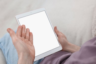 Photo of Sick man having online consultation with doctor via tablet at home, closeup