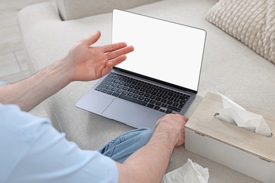 Photo of Sick man having online consultation with doctor via laptop at home, closeup