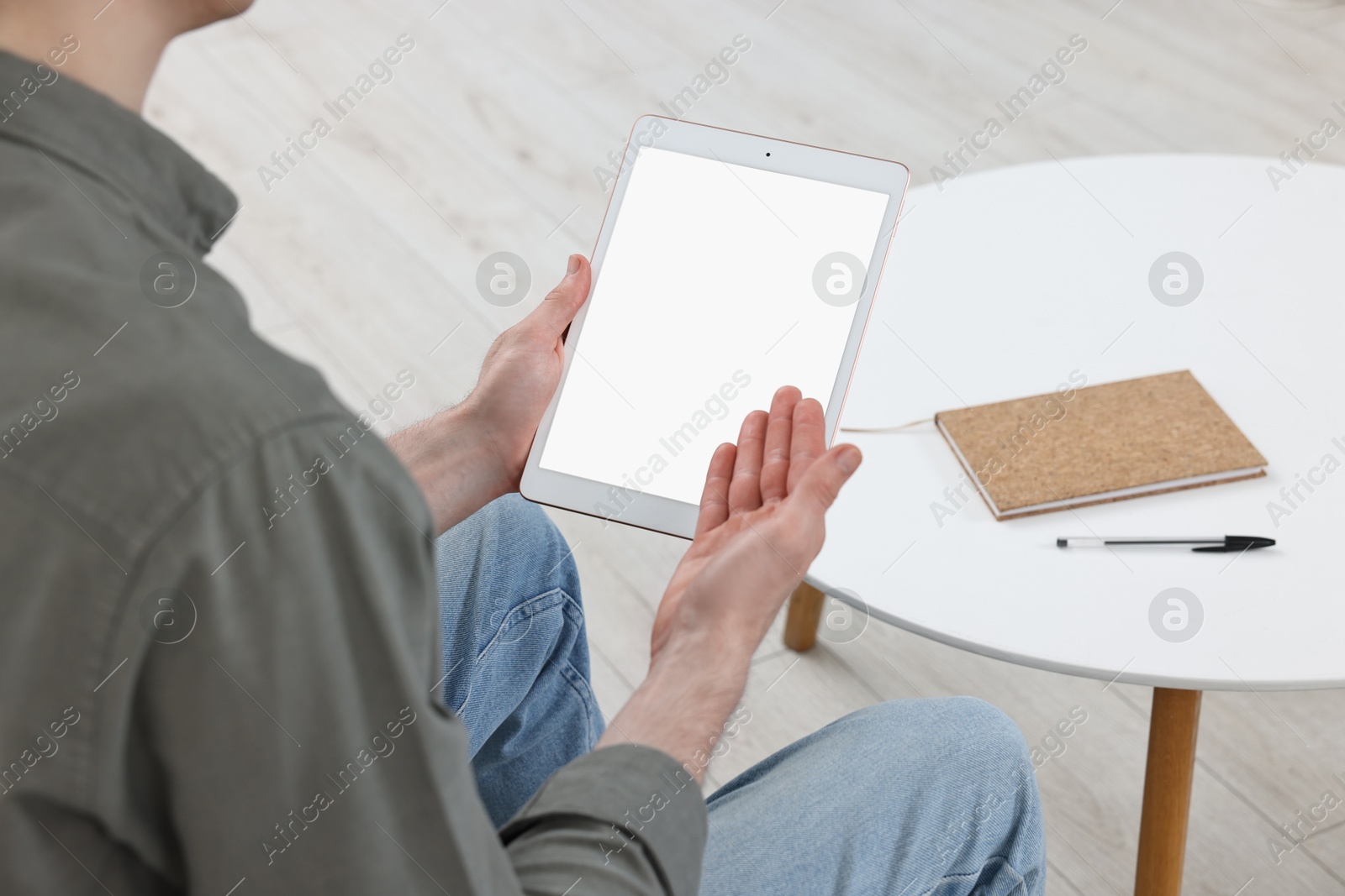 Photo of Sick man having online consultation with doctor via tablet at home, closeup