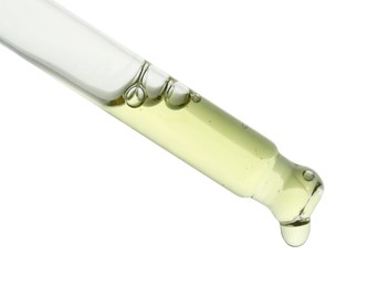 Photo of Dripping natural cosmetic oil on white background